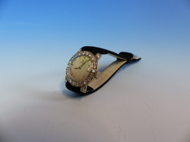 A LADIES PLATINUM AND DIAMOND WATCH FITTED WITH A VINTAGE OMEGA MANUAL WOUND MOVEMENT. THE INSIDE - Image 12 of 18