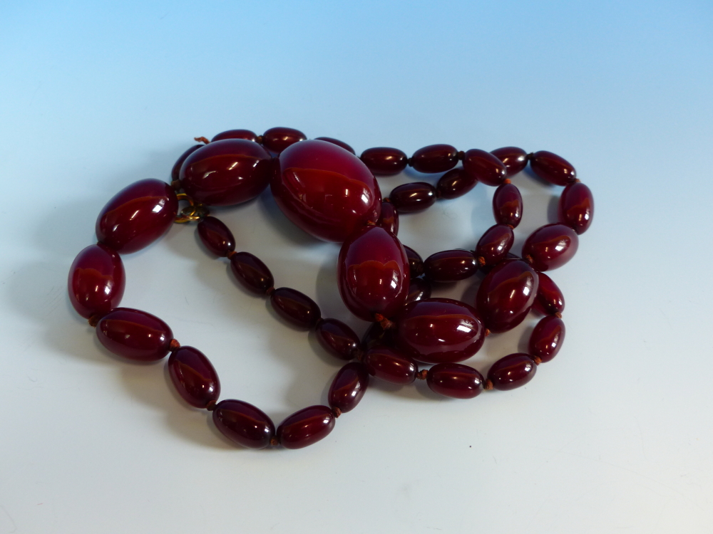 A GRADUATED ROW OF CHERRY AMBER BEADS, KNOTTED. LENGTH 76cms, WEIGHT 60 grams. - Image 3 of 21