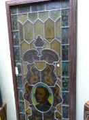 AN OLD STAINED GLASS LEADED PANEL LATER MOUNTED IN A WOODEN FRAME. 67 x 204cms.