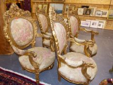 A SET OF FOUR CARVED GILTWOOD ARMCHAIRS TOGETHER WITH A SETTEE, EACH WITH PIERCED FOLIATE