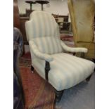 A VICTORIAN DEEP SEAT LOW ARMCHAIR ON TURNED FORELEGS WITH LATER PALE BLUE STRIPE UPHOLSTERY.