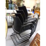 A SET OF EIGHT HERMAN MILLER BLACK CANTILEVER ARMCHAIRS.