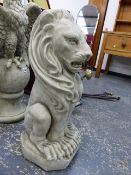 A PAIR OF COMPOSITE STONE SEATED LION GARDEN STATUES.