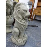 A PAIR OF COMPOSITE STONE SEATED LION GARDEN STATUES.