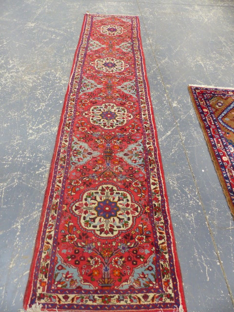 A PERSIAN HAMADAN RUNNER. 390 x 82cms.