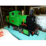 A SCRATCH BUILT LIVE STEAM 0-4-0 LOCOMOTIVE DISPLAYED IN GLAZED CASE.