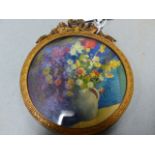 DAY, A MINIATURE WATERCOLOUR OF A JUG OF FLOWERS, WITHIN RIBBON TOPPED GILT METAL FRAME. Dia.8.