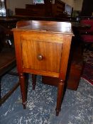 A MAHOGANY BEDSIDE CUPBOARD WITH 3/4 GALLERY TOP, THE TAPERING CYLINDRICAL LEGS ON SPINDLE FEET.
