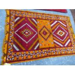 A NORTH AFRICAN TRIBAL RUG. 323 x 152cms.