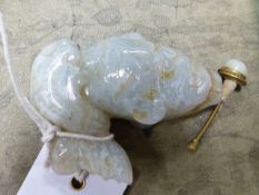 A CHINESE GREEN/GREY HARDSTONE SNUFF BOTTLE, STOPPER AND WOODEN STAND CARVED AS A CARP LEAPING