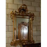 A LARGE CARVED GILTWOOD ITALIAN BAROQUE STYLE MARGINAL MIRROR. 184 x 124cms.