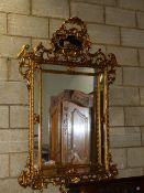 A LARGE CARVED GILTWOOD ITALIAN BAROQUE STYLE MARGINAL MIRROR. 184 x 124cms.