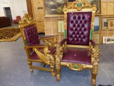 TWO CARVED AND GILDED WOOD THRONE CHAIRS WITH BUTTON UPHOLSTERED BACKS.