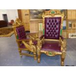 TWO CARVED AND GILDED WOOD THRONE CHAIRS WITH BUTTON UPHOLSTERED BACKS.