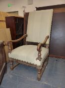 AN ANTIQUE FLEMISH WALNUT HIGH BACK OPEN ARMCHAIR ON TURNED SUPPORTS UNITED BY STRETCHERS.