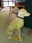 A PAIR OF WEATHERED LIFE SIZE GARDEN FIGURES OF SEATED DOGS.