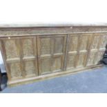 AN INDIAN HARDWOOD CABINET WITH FOUR PANELLED DOORS CARVED WITH BIRDS AND FOLIAGE BELOW A CORNICE