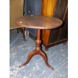 AN 18TH CENTURY OAK TRIPOD TABLE, THE CIRCULAR TOP ON BALUSTER COLUMN, DOWNSWEPT LEGS WITH LONG NOSE