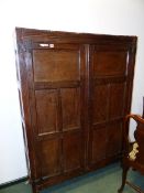 AN 18th.C.OAK CABINET WITH TWO FIVE PANELLED DOORS ENCLOSING SHELVING ABOVE STILE FEET. 173 x 127