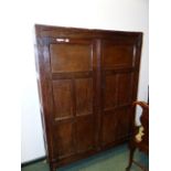 AN 18th.C.OAK CABINET WITH TWO FIVE PANELLED DOORS ENCLOSING SHELVING ABOVE STILE FEET. 173 x 127