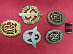 THREE THIRD REICH NATIONAL SPORTS BADGES, BRONZE, SILVER AND GOLD, AN SA SPORTS BADGE AND A THIRD