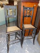 A PAIR OF ANTIQUE EBONISED LYRE BACKED CORRECTION CHAIRS WITH CANED SEATS