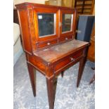 A 19th.C.MAHOGANY WRITING DESK, THE MIRRORED DOORS OVER TWO DRAWERS RECESSED ABOVE A BRASS