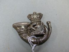 A WHITE METAL CAP BADGE, POSSIBLY FOR THE LORNE RIFLES.