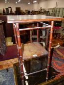AN ARTS AND CRAFTS TWO TIER OCCASIONAL TABLE IN THE MANNER OF GODWIN. 39 x 39 x H.69cms.