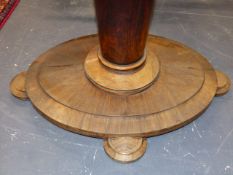 A ROSEWOOD OVAL BREAKFAST TABLE TILTING ON TAPERED CYLINDRICAL COLUMN ON PLINTH AND FOUR STEPPED