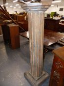 A CARVED AND PAINTED COLUMN FORM PEDESTAL WITH OCTAGONAL TOP ABOVE FLUTED SHAFT AND PLINTH BASE. H.