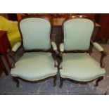 A PAIR OF FRENCH LOUIS XV STYLE CARVED ARMCHAIRS WITH SHAPED BACKS AND SEATS.