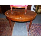 AN ANTIQUE NEO CLASSICAL STYLE WALNUT OVAL TABLE INLAID WITH PAIRS OF HERRING BONE CHEQUER BANDS