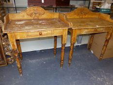 A PAIR OF OCHRE PAINTED VICTORIAN PINE WASHSTANDS, THE THREE QUARTER GALLERIED RECTANGLUAR TOPS