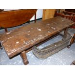 AN ANTIQUE OAK WORK TOP LATER MOUNTED AS A BENCH LENGTH LOW TABLE. 181 x 55 x H.49cms.