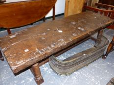 AN ANTIQUE OAK WORK TOP LATER MOUNTED AS A BENCH LENGTH LOW TABLE. 181 x 55 x H.49cms.