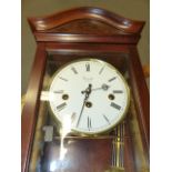 A COMMITTI MAHOGANY CASED CHIMING WALL CLOCK. H.58cms.