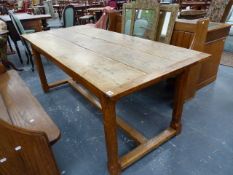 AN OAK REFECTORY TABLE WITH CLEATED THREE PLANK TOP ON OCTAGONAL LEGS JOINED ABOVE THE FEET BY AN