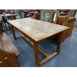 AN OAK REFECTORY TABLE WITH CLEATED THREE PLANK TOP ON OCTAGONAL LEGS JOINED ABOVE THE FEET BY AN