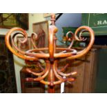 A THONET STYLE BENTWOOD COAT AND STICKSTAND, SIX HOOKS RAISED ON THE COLUMN OF QUATREFOIL SECTION