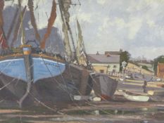 20th.C.BRITISH SCHOOL. FISHING BOATS AT LOW TIDE, SIGNED INDISTINCTLY OIL ON BOARD. 38 x 60.5cms.