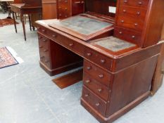 A VICTORIAN MAHOGANY DICKENS DESK WITH TWO BANKS OF FOUR DRAWERS FLANKING WRITING SLOPE OVER TWO