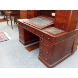 A VICTORIAN MAHOGANY DICKENS DESK WITH TWO BANKS OF FOUR DRAWERS FLANKING WRITING SLOPE OVER TWO