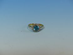 AN 18ct AND PLATINUM BLUE ZIRCON AND DIAMOND CLUSTER RING. FINGER SIZE L.