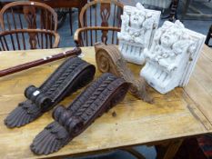 A PAIR OF STAINED PINE LEAF CARVED SCROLL BRACKETS. H.50cms ANOTHER PINE BRACKET AND A PAIR OF