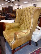 A GEO.III. STYLE LEATHER UPHOLSTERED WING BACK ARMCHAIR.