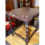 A WALNUT LOW TABLE, THE WAVY EDGED RECTANGULAR TOP ON BARLEY TWIST LEGS AND STRETCHERS. 58 x 49 x