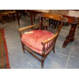 A LATE VICTORIAN WALNUT FRAME LOW ARMCHAIR IN THE ARTS AND CRAFTS MANNER.