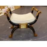 A THOMAS HOPE STYLE GILT AND EBONISED STOOL, ARMS RAISED ABOVE THE UPHOLSTERED SEAT, X SHAPE