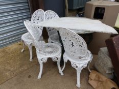 A MARBLE TOP PUB TABLE WITH BRITANNIA SUPPORTS AND FOUR VICTORIAN STYLE GARDEN CHAIRS. Dia.60cms.
